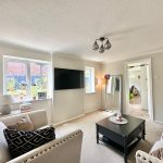 Bright living room with modern decor and garden view.