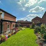 Sunny garden with flowers and lawn