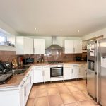 Modern kitchen with appliances and wooden cabinets.