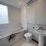 Modern bathroom with bathtub and sink.