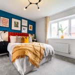 Modern bedroom with colourful art and cosy decor.