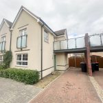 Modern semi-detached house with balcony and driveway.