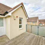 Suburban house deck with glass railing view.