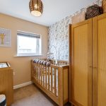 Cosy baby nursery with cot and changing table.