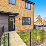 Modern brick house with driveway and garden