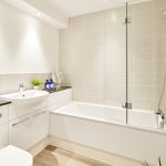Modern bathroom with bathtub and sink area.