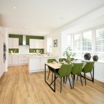Modern kitchen and dining area with green accents.