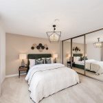 Modern bedroom with mirrored wardrobe and chandelier