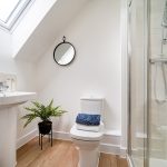 Modern bathroom with shower and plant decor
