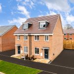 Modern red brick houses with driveway and garden