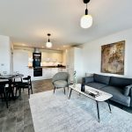 Modern open-plan living room with kitchen and dining area.