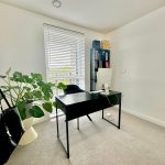 Minimalist home office with desk and plant
