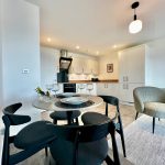 Modern kitchen and dining area with elegant furniture.