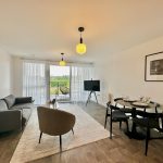 Modern apartment living room with balcony view.