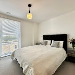 Modern bedroom with large windows and stylish decor