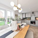Modern kitchen with dining table and garden view.