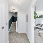 Modern hallway leading to stylish living room