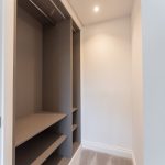 Spacious modern wardrobe interior with shelves.