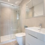 Modern bathroom with glass shower and white sink