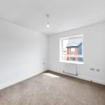 Bright empty room with carpet and window view.