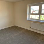 Empty room with carpet and large window