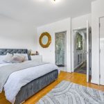 Modern bedroom with ensuite and stylish decor.