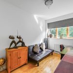 Bright study with sofa and wooden cabinet