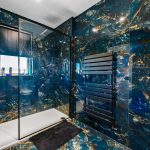 Luxurious bathroom with black marble walls and shower