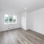 Empty room with wooden floor and large window