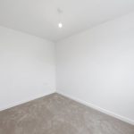 Empty room with white walls and carpet