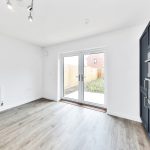 Empty modern kitchen with patio doors and oven.