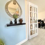 Home office with mirror and desk setup