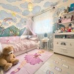 Whimsical children's bedroom with mural and toys.
