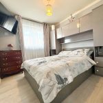 Modern bedroom with double bed and TV