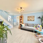 Cosy living room with staircase and baby jumper