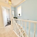 Upstairs hallway with bathroom and stairs