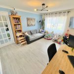 Cosy living room with toys and desk workspace.