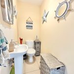 Nautical-themed bathroom with anchor and star decor.
