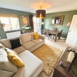 Cosy living room with sofa and dining table.
