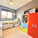Children's bedroom with colourful furniture and toys.