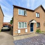 Two-storey brick house with driveway and car.