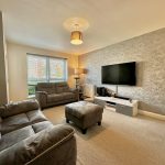Modern living room with TV and sofas.