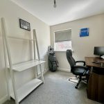Minimalist home office with desk and chair.