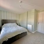 Modern bedroom with double bed and neutral decor