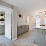 Modern kitchen with utility room and island.