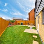 Modern garden with patio and wooden fencing
