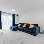 Modern living room with blue sofa and cushions