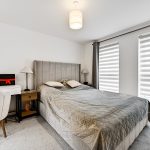 Modern bedroom with grey decor and natural light
