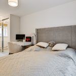 Cosy bedroom with desk and mirrored wardrobe