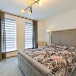 Modern bedroom with double bed and unique lighting.